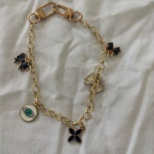 Gold Tone Charm Bracelet Evil Eye Bow & Floral Charms Adjustable Chain Bracelet
